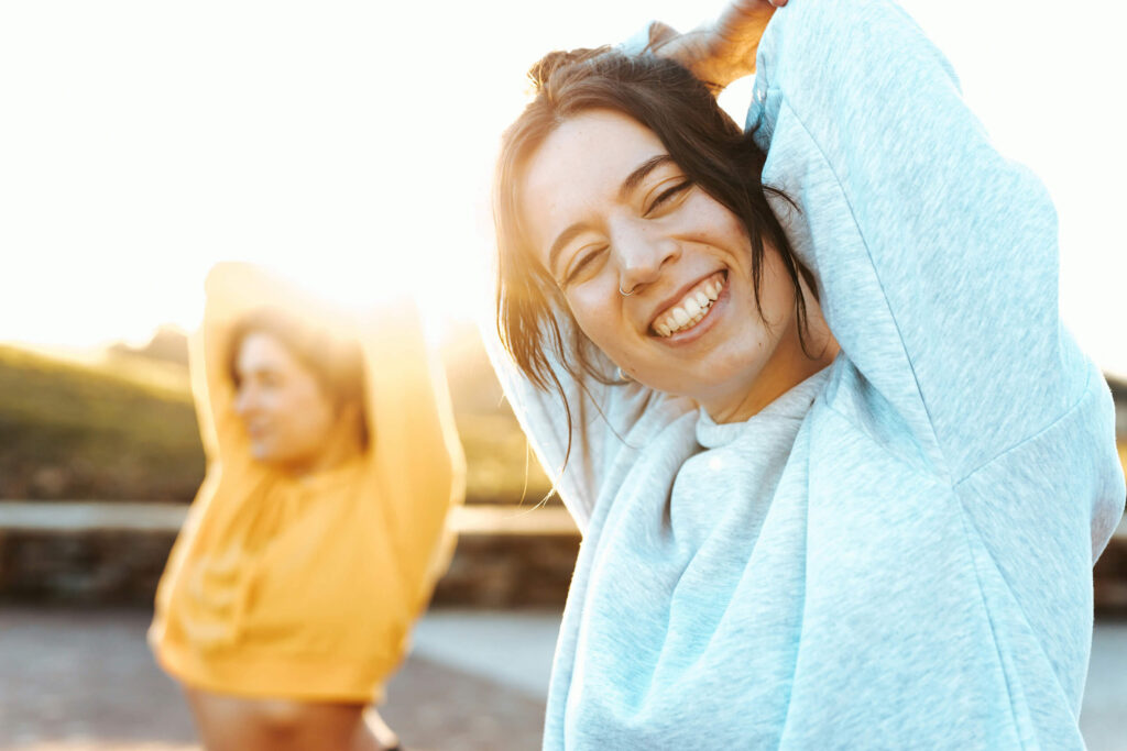 Women stretching and smiling after spinal decompression at Greenbrier Family Chiropractic in Chesapeake, VA