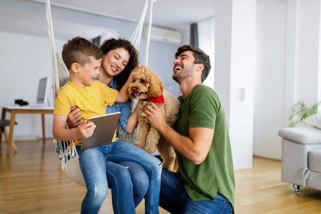 Family and dog in living room after visiting Greenbrier Family Chiropractic in Chesapeake, VA for family care