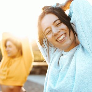 Women stretching and smiling after spinal decompression at Greenbrier Family Chiropractic in Chesapeake, VA