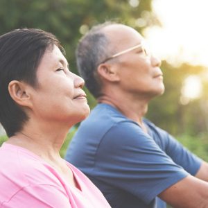 Older couple sitting outside after relief from carpal tunnel pain at Greenbrier Family Chiropractic in Chesapeake, VA