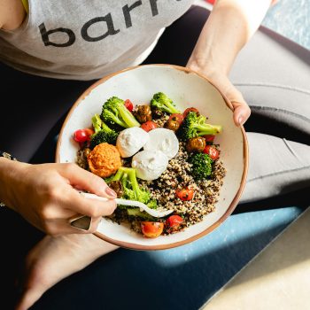 Woman eating grain bowl after nutrition consultation at Greenbrier Family Chiropractic in Chesapeake, VA